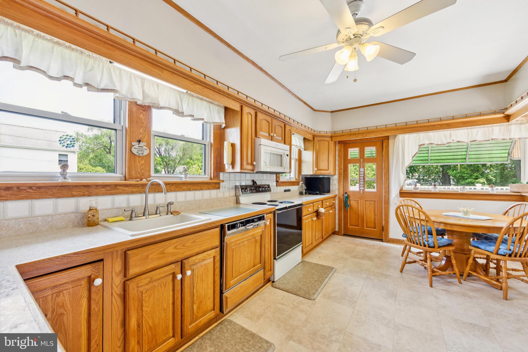 615 Convent Road Aston, PA 19014 - Photo 13 of 39 a kitchen with stainless steel appliances granite countertop sink window and dining table