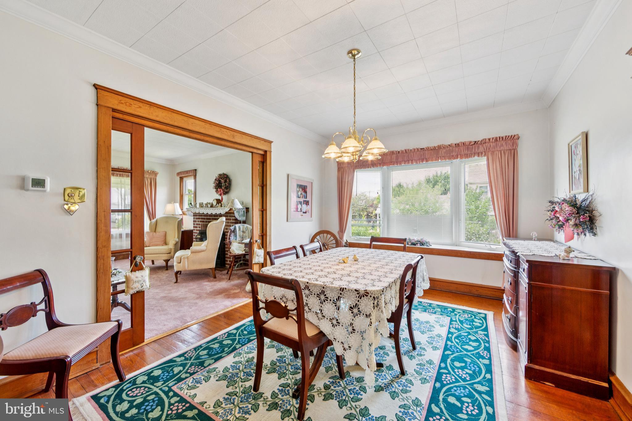 615 Convent Road Aston, PA 19014 - Photo 16 of 39 a view of a dining room and livingroom with furniture wooden floor a chandelier