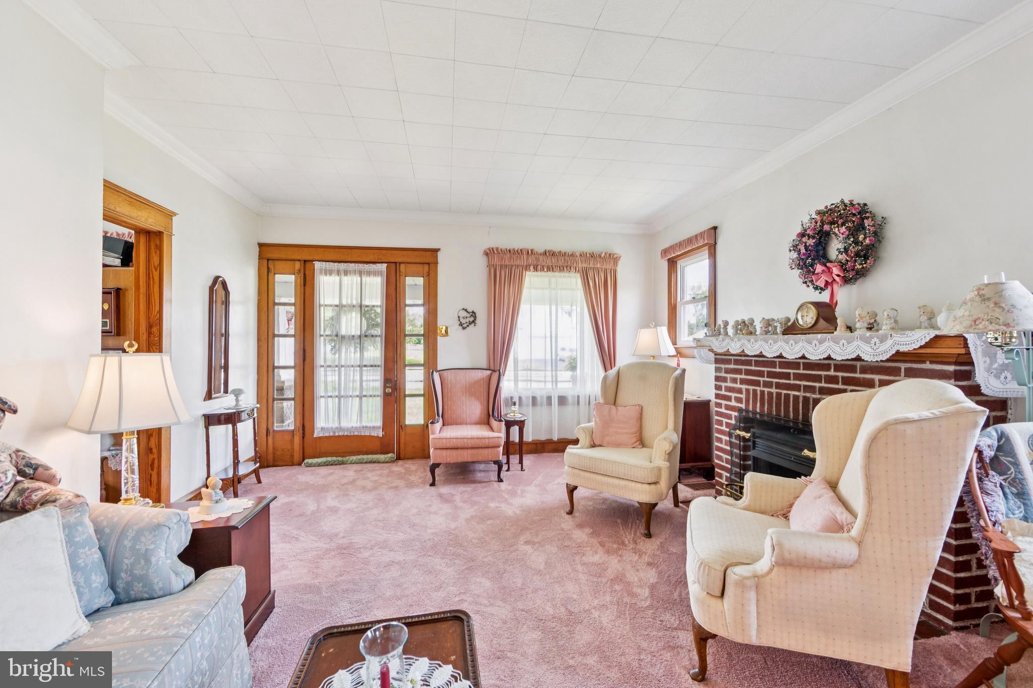 615 Convent Road Aston, PA 19014 - Photo 9 of 39 a living room with furniture fireplace and large windows