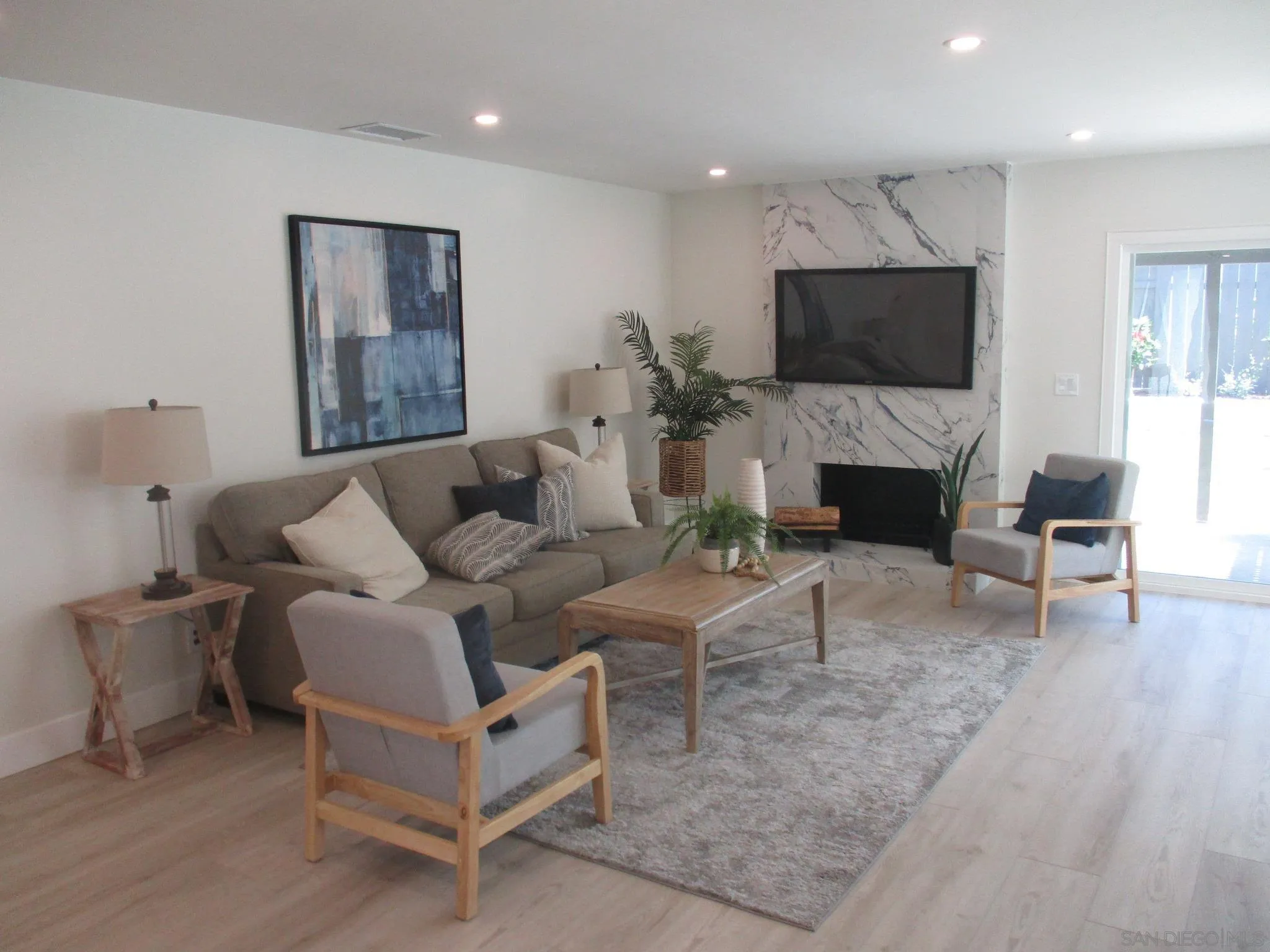141 Solace Court Encinitas, CA 92024 - Photo 2 of 16 a living room with furniture and a flat screen tv