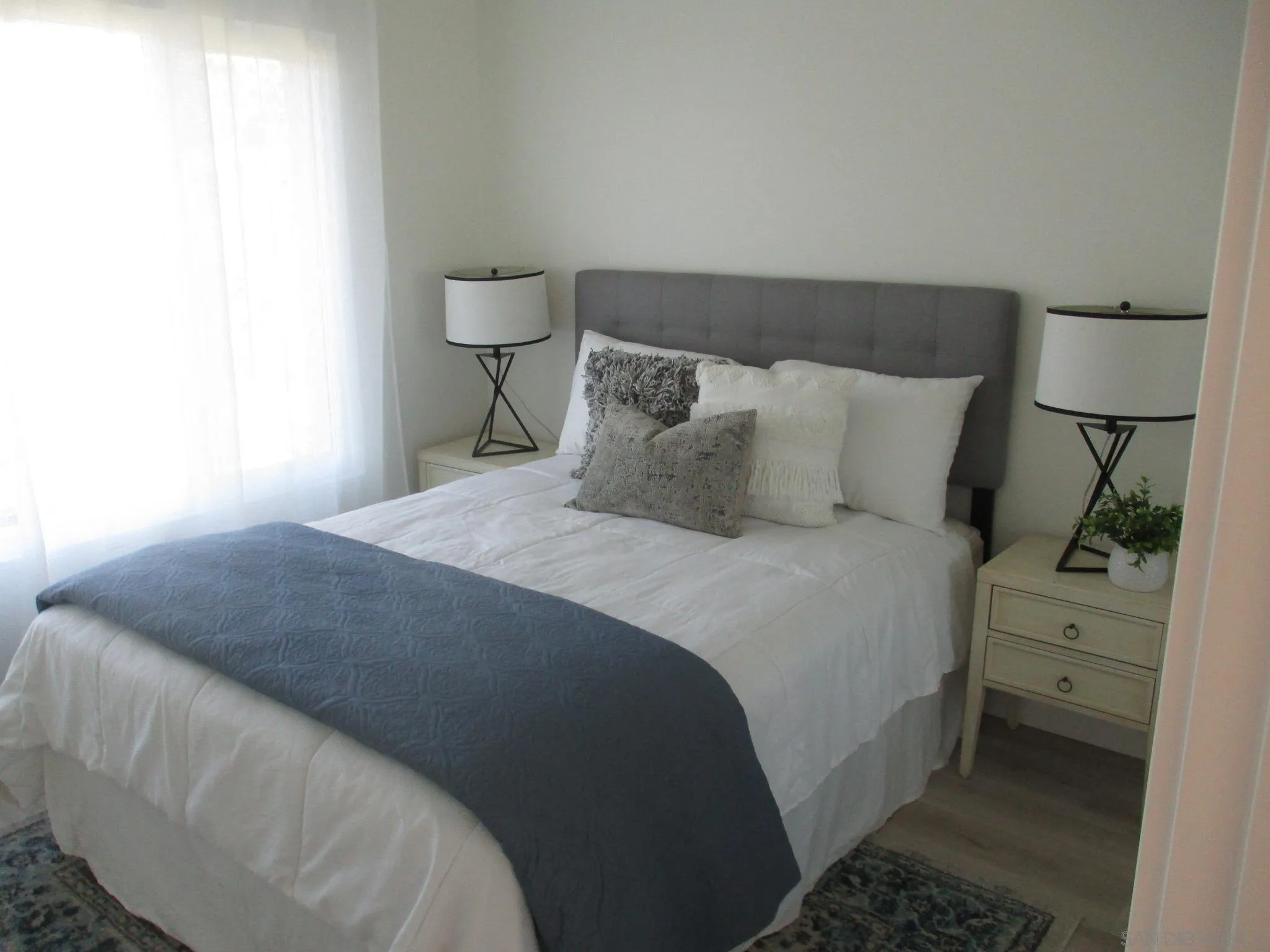 141 Solace Court Encinitas, CA 92024 - Photo 6 of 16 a bedroom with a bed and a lamp