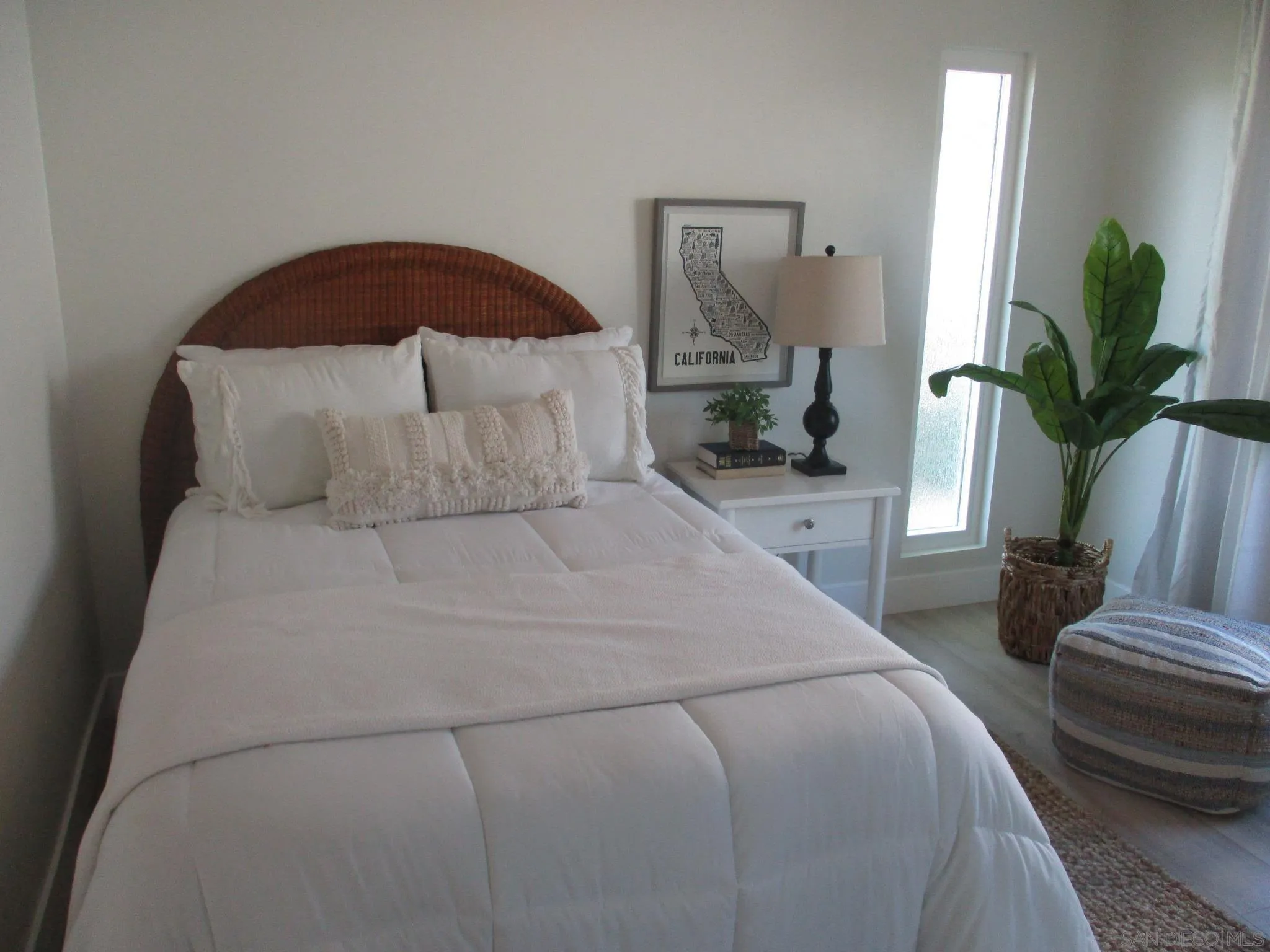 141 Solace Court Encinitas, CA 92024 - Photo 7 of 16 a bedroom with a large bed and a potted plant