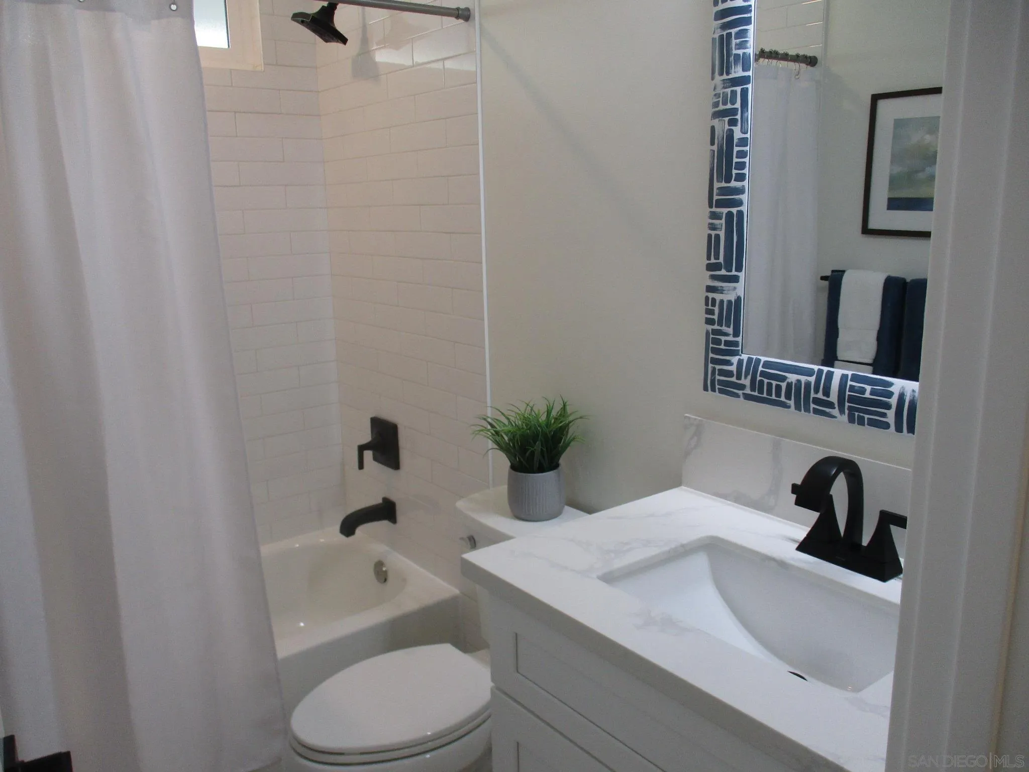 141 Solace Court Encinitas, CA 92024 - Photo 8 of 16 a bathroom with a sink toilet a mirror and shower