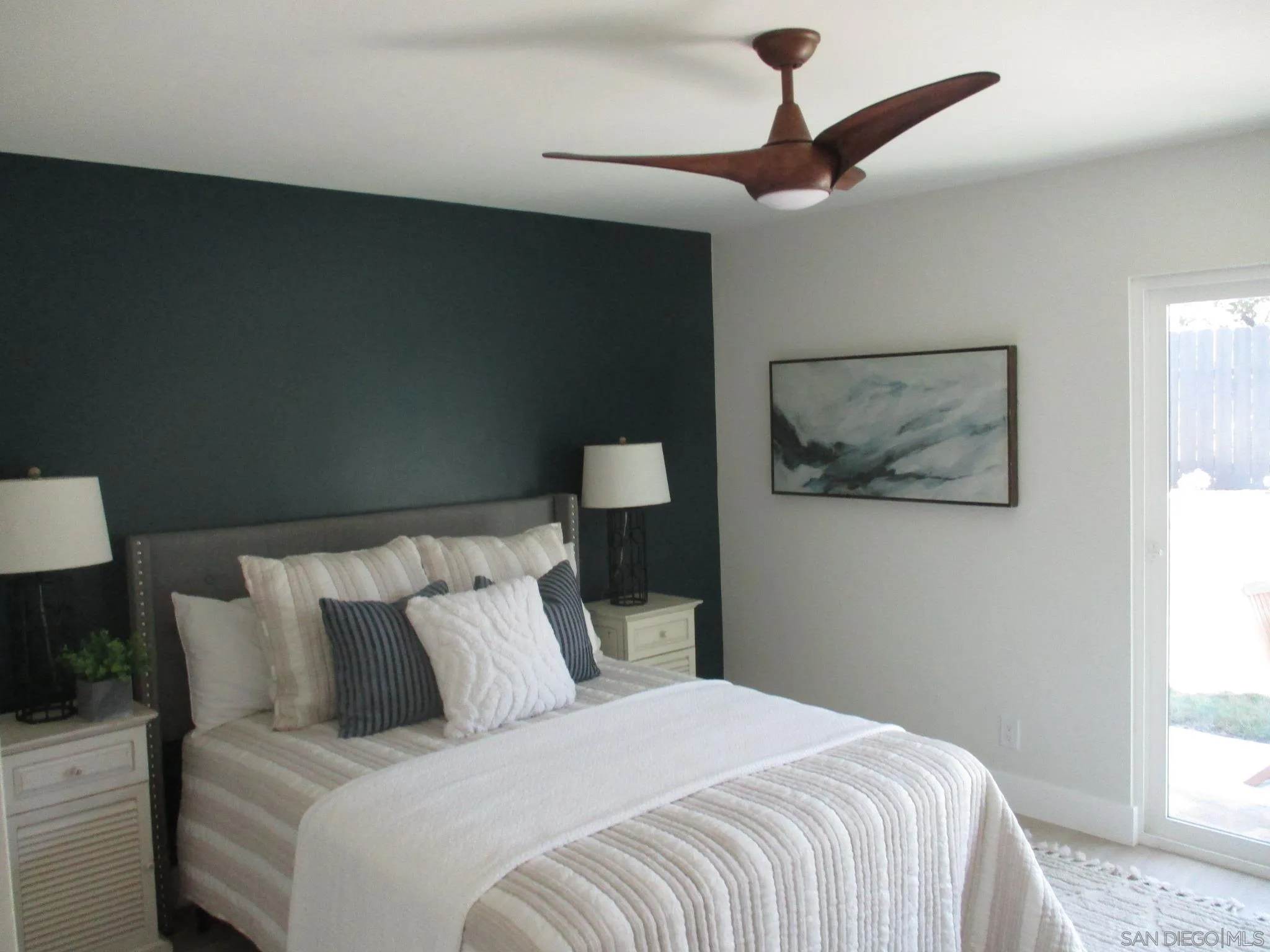 141 Solace Court Encinitas, CA 92024 - Photo 9 of 16 a bedroom with a bed and a painting on the wall