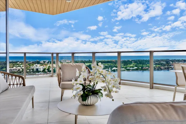 a view of a balcony with lake view and sitting space