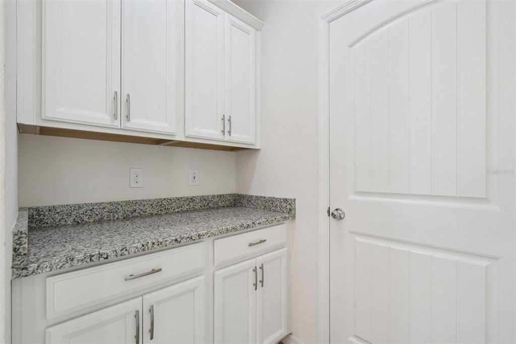 16031 Pebble Blf Loop Winter Garden, FL 34787 - Photo 11 of 51 a kitchen with granite countertop white cabinets and a sink