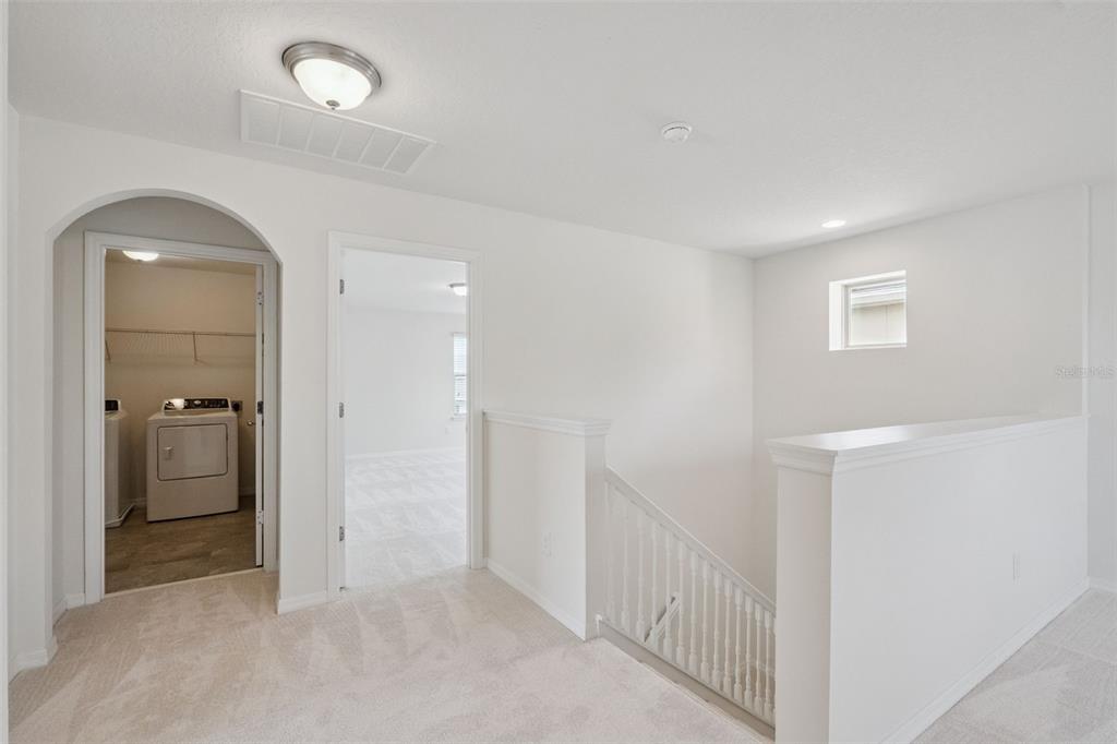 16031 Pebble Blf Loop Winter Garden, FL 34787 - Photo 14 of 51 a view of a hallway with a livingroom and a bathroom