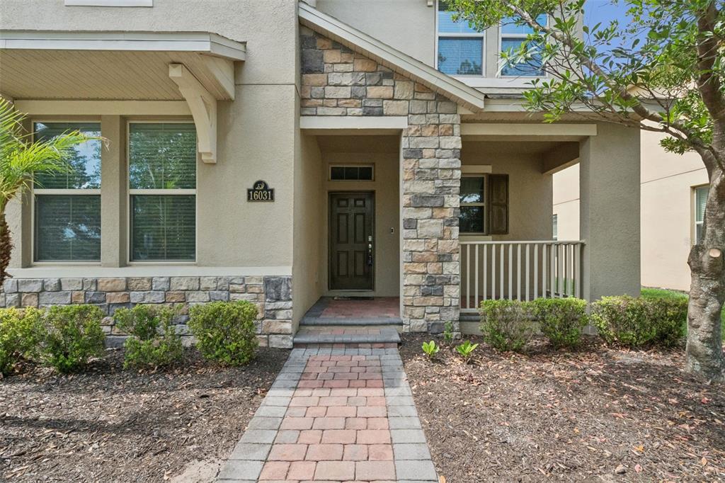 16031 Pebble Blf Loop Winter Garden, FL 34787 - Photo 2 of 51 a front view of a house with a porch