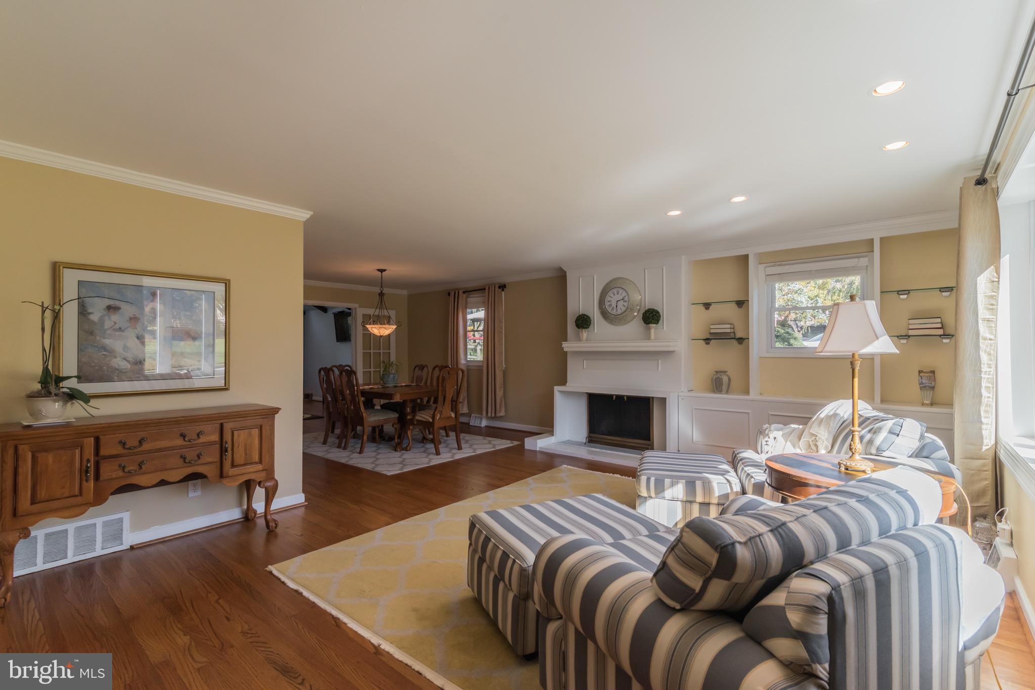 1376 Michael Road Jenkintown, PA 19046 - Photo 3 of 30 a living room with furniture a fireplace and a table with wooden floor