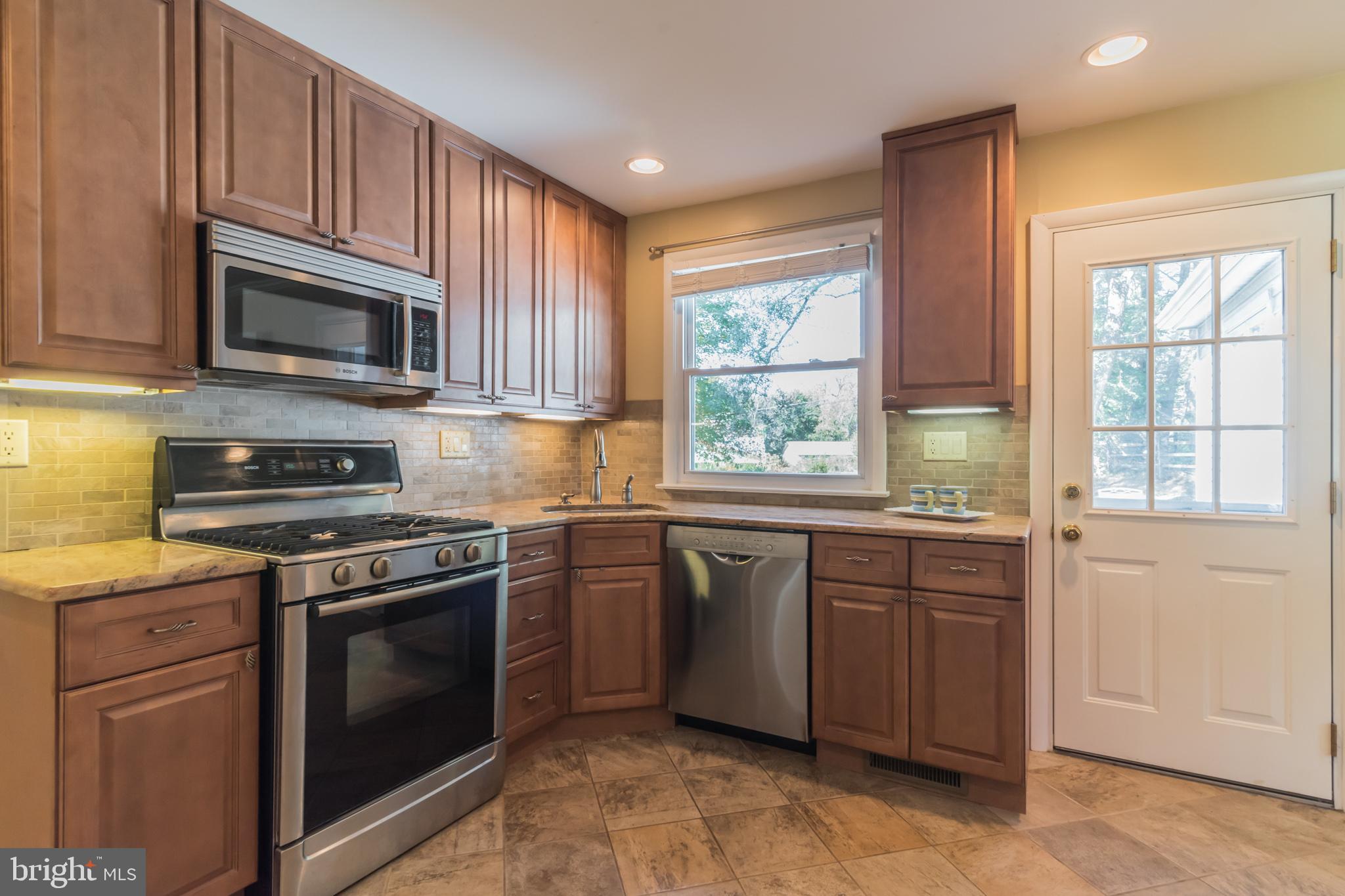 1376 Michael Road Jenkintown, PA 19046 - Photo 9 of 30 a kitchen with granite countertop wooden cabinets stainless steel appliances and a window