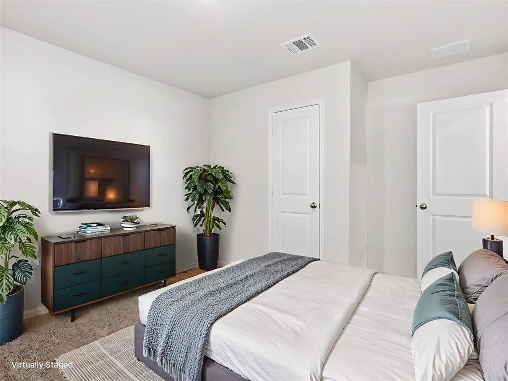 757 Tiger Lily Way Pilot Point, TX 76258 - Photo 11 of 16 a bedroom with a bed and a flat screen tv