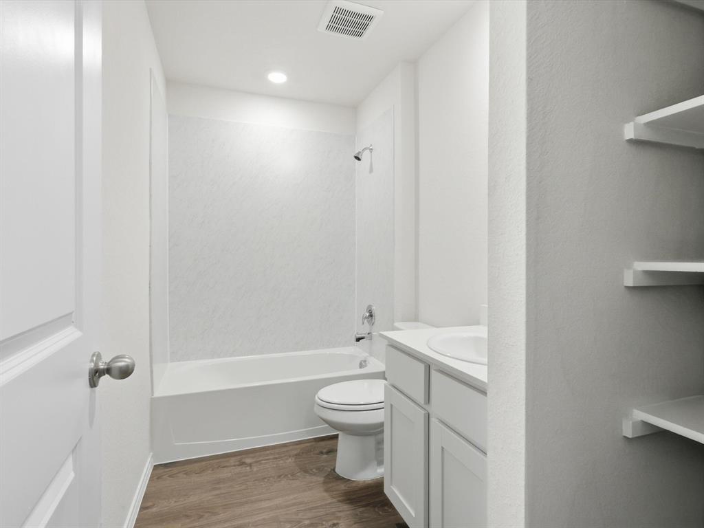 757 Tiger Lily Way Pilot Point, TX 76258 - Photo 13 of 16 a bathroom with a toilet a sink and bathtub