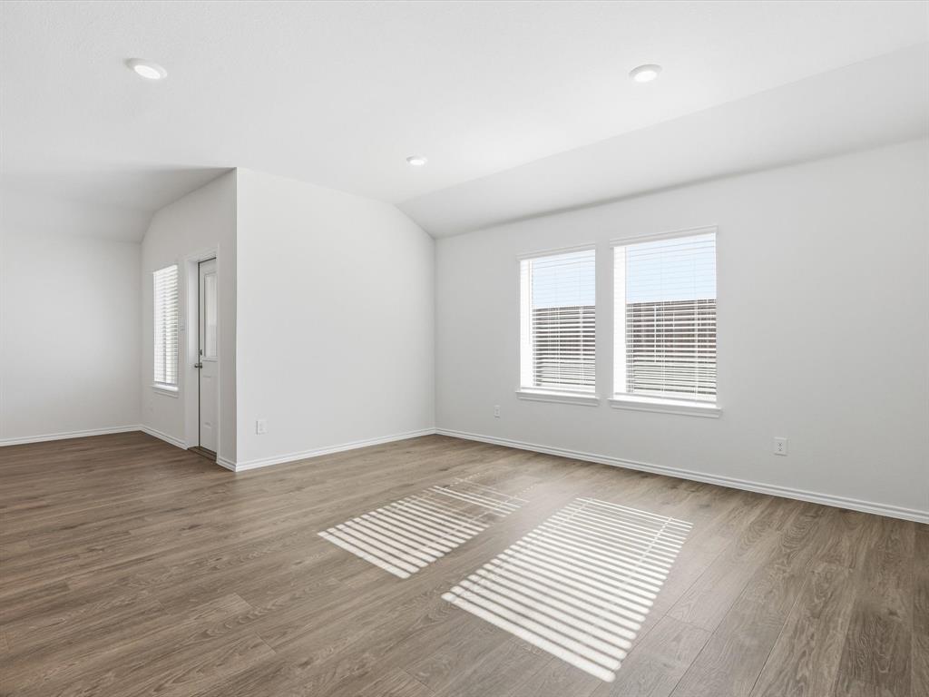 757 Tiger Lily Way Pilot Point, TX 76258 - Photo 3 of 16 an empty room with wooden floor and windows