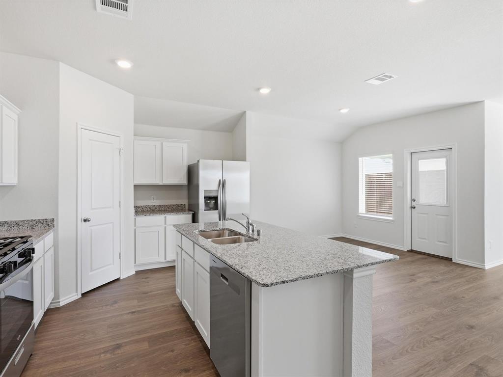 757 Tiger Lily Way Pilot Point, TX 76258 - Photo 5 of 16 a kitchen with stainless steel appliances granite countertop a sink stove and refrigerator