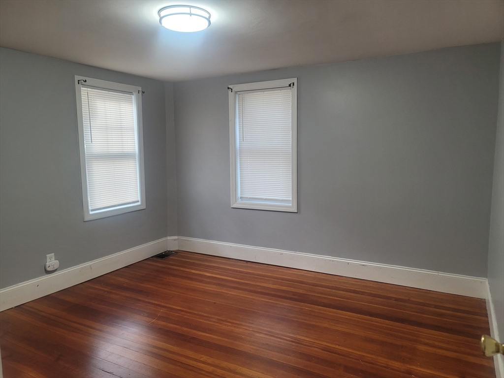 237 Colburn Street, Unit 237 Dedham, MA 02026 - Photo 14 of 16 a view of a room with wooden floor and windows in it