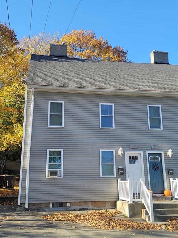 237 Colburn Street, Unit 237 Dedham, MA 02026 - Photo 2 of 16 a front view of a house with a yard