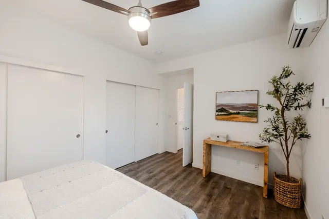 a bedroom with a bed and a potted plant