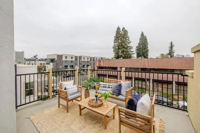 a view of a balcony with chairs and wooden floor
