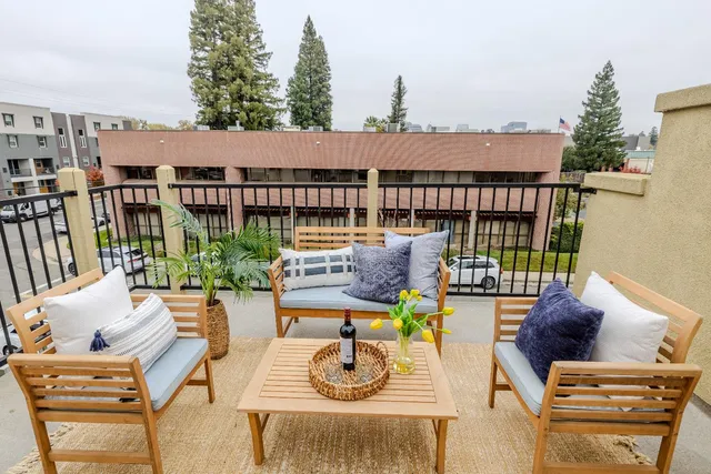 a balcony with furniture and a potted plant