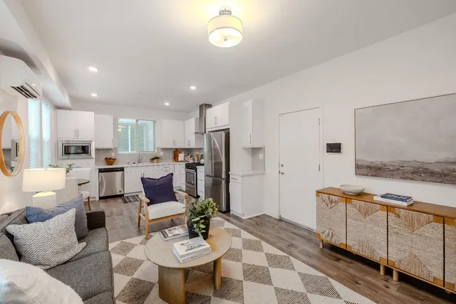 a living room with furniture and kitchen view