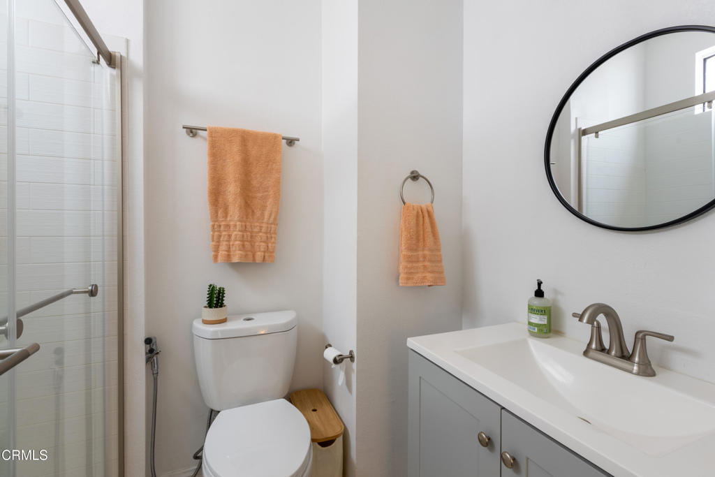 12007 Rochester Avenue, Unit 1 Los Angeles, CA 90025 - Photo 27 of 32 a bathroom with a toilet sink vanity and mirror