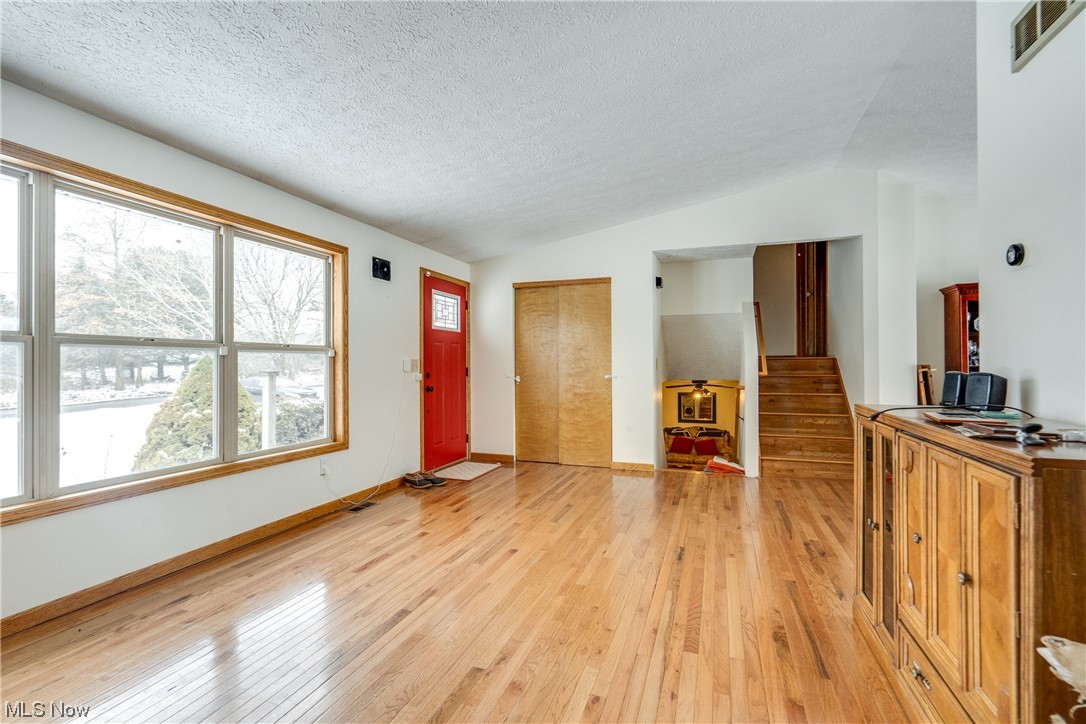 5303 Laubert Road Atwater, OH 44201 - Photo 11 of 37 Entrance foyer with vaulted ceiling, light hardwood / wood-style floors, and a textured ceiling