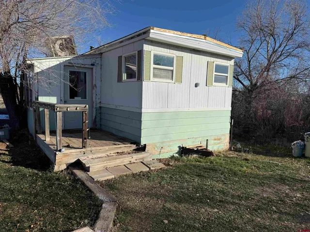 a backyard of a house with yard fire pit and barbeque oven