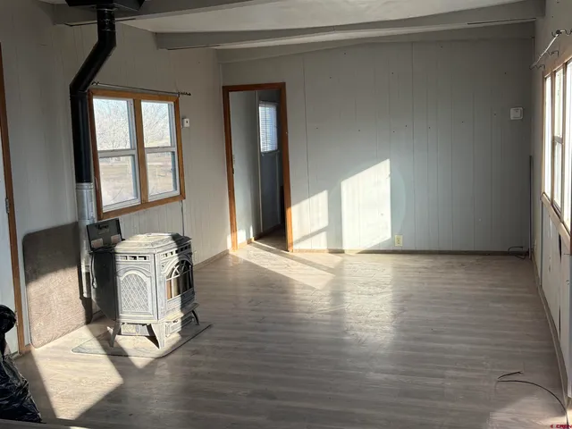 a view of a livingroom with wooden floor and a window