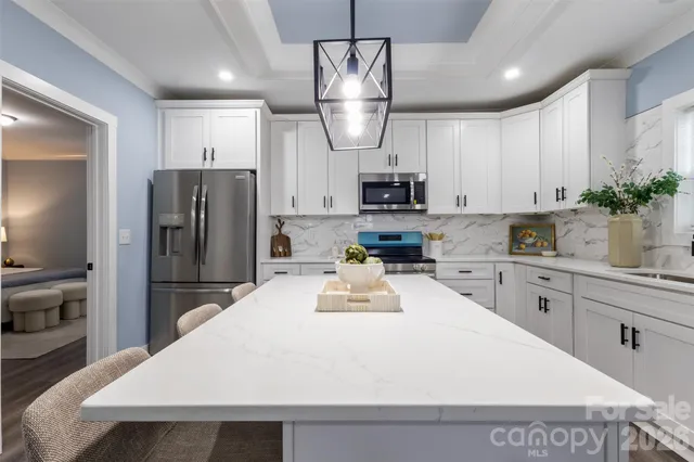 a kitchen with stainless steel appliances a refrigerator sink and microwave