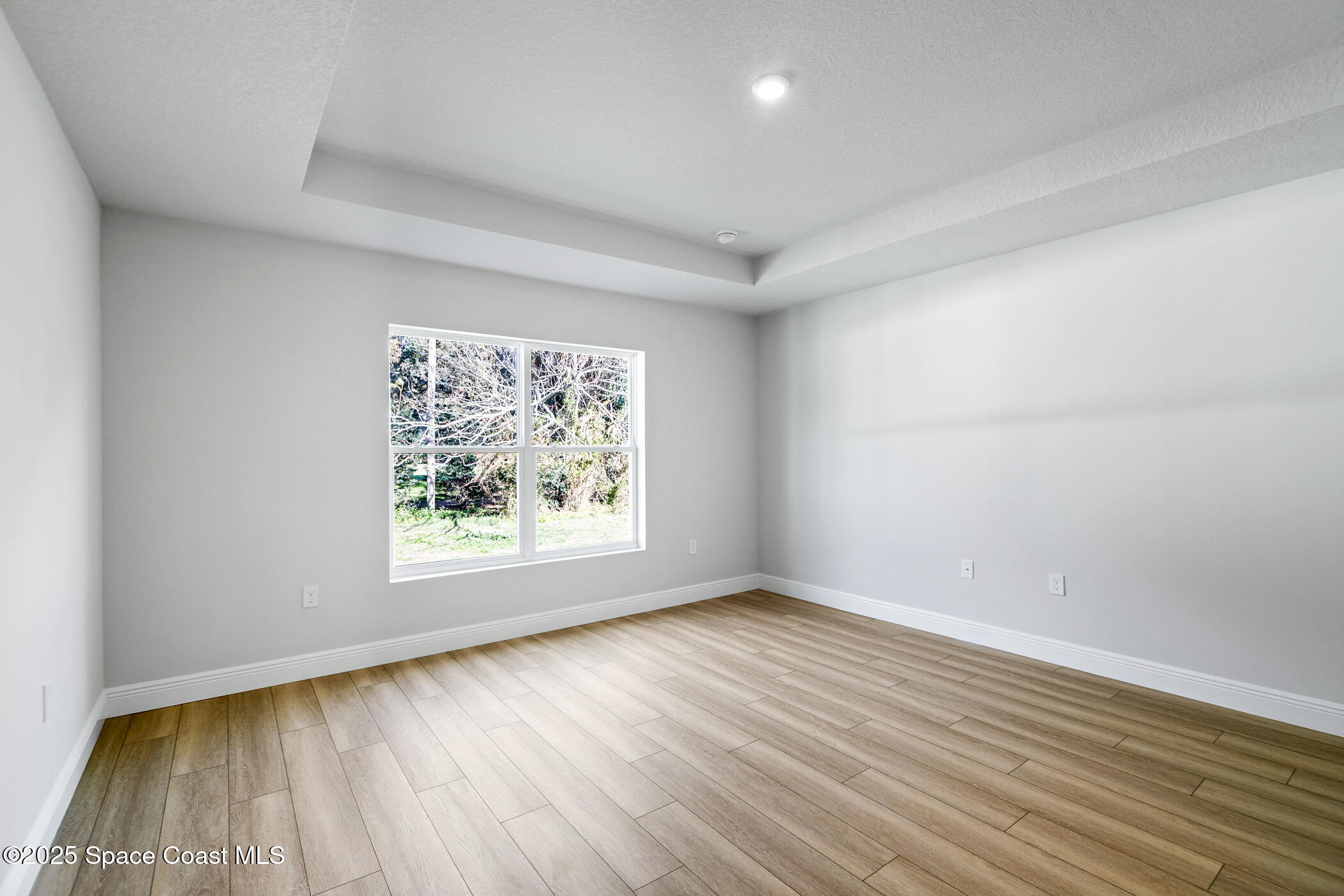 5435 Southeast 91st Street Ocala, FL 34480 - Photo 22 of 44 wooden floor in an empty room with a window