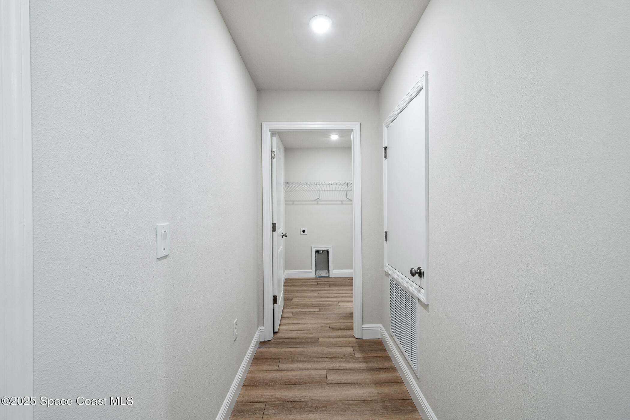5435 Southeast 91st Street Ocala, FL 34480 - Photo 24 of 44 a view of a hallway with wooden floor and a bathroom