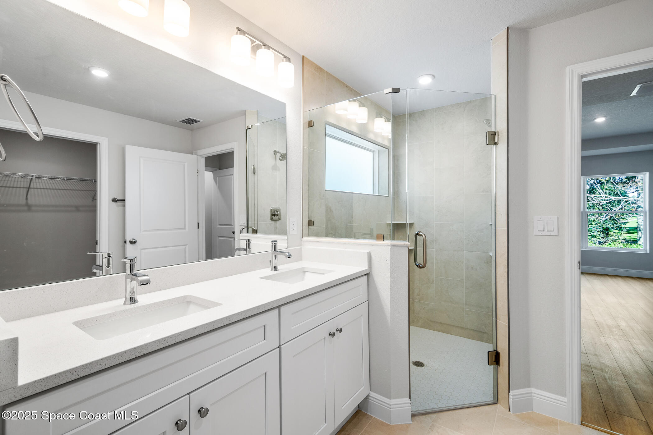 5435 Southeast 91st Street Ocala, FL 34480 - Photo 25 of 44 a bathroom with a double vanity sink mirror and shower