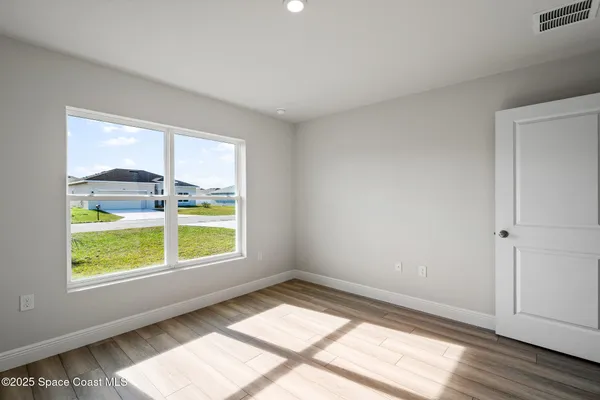 a view of an empty room and wooden floor