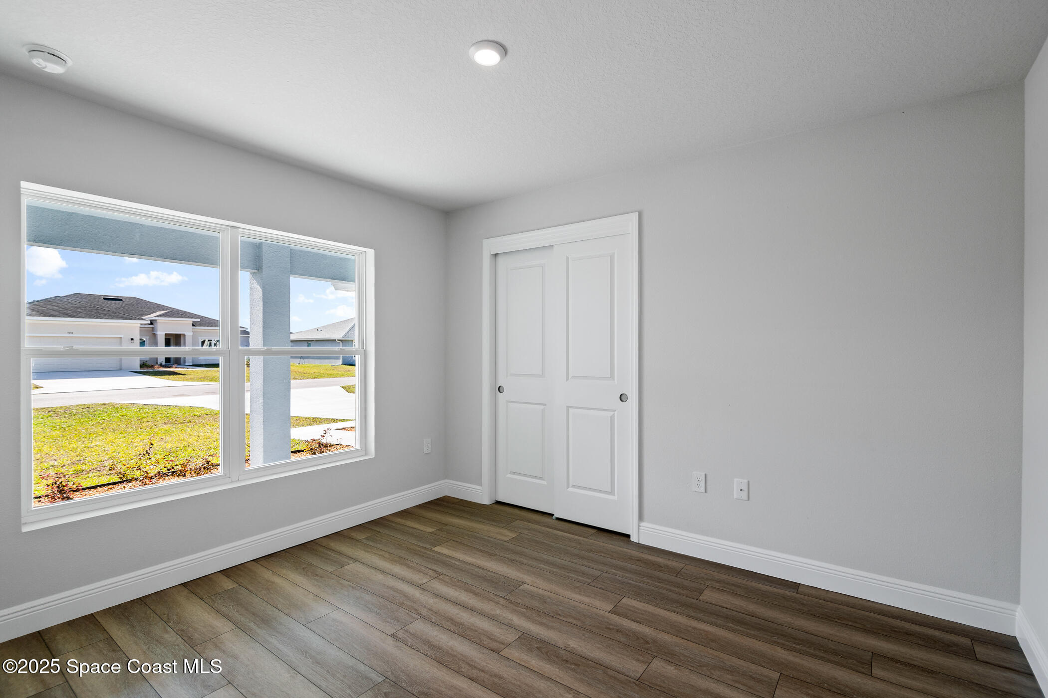 5435 Southeast 91st Street Ocala, FL 34480 - Photo 35 of 44 wooden floor in an empty room with a window