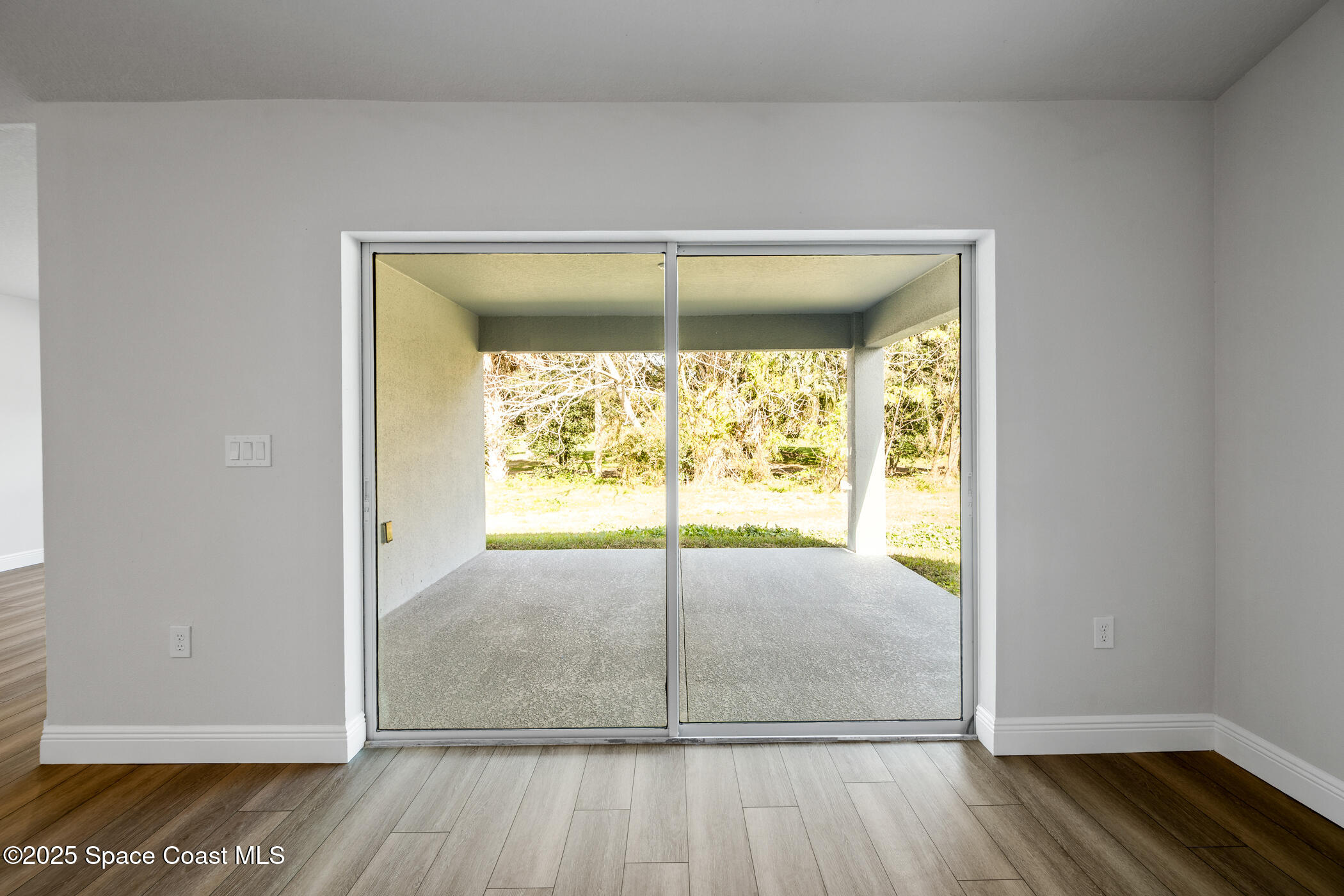 5435 Southeast 91st Street Ocala, FL 34480 - Photo 10 of 44 a view of a room with wooden floor and window