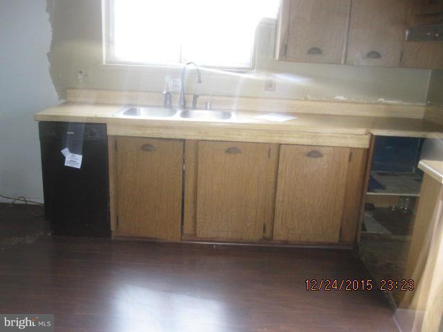 6117 Collinsway Road Catonsville, MD 21228 - Photo 3 of 11 a kitchen with a sink and cabinets