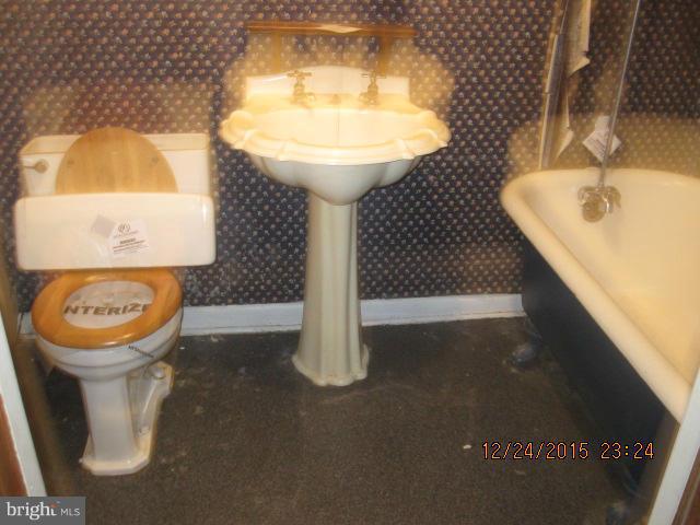 6117 Collinsway Road Catonsville, MD 21228 - Photo 10 of 11 a bathroom with a sink toilet and mirror