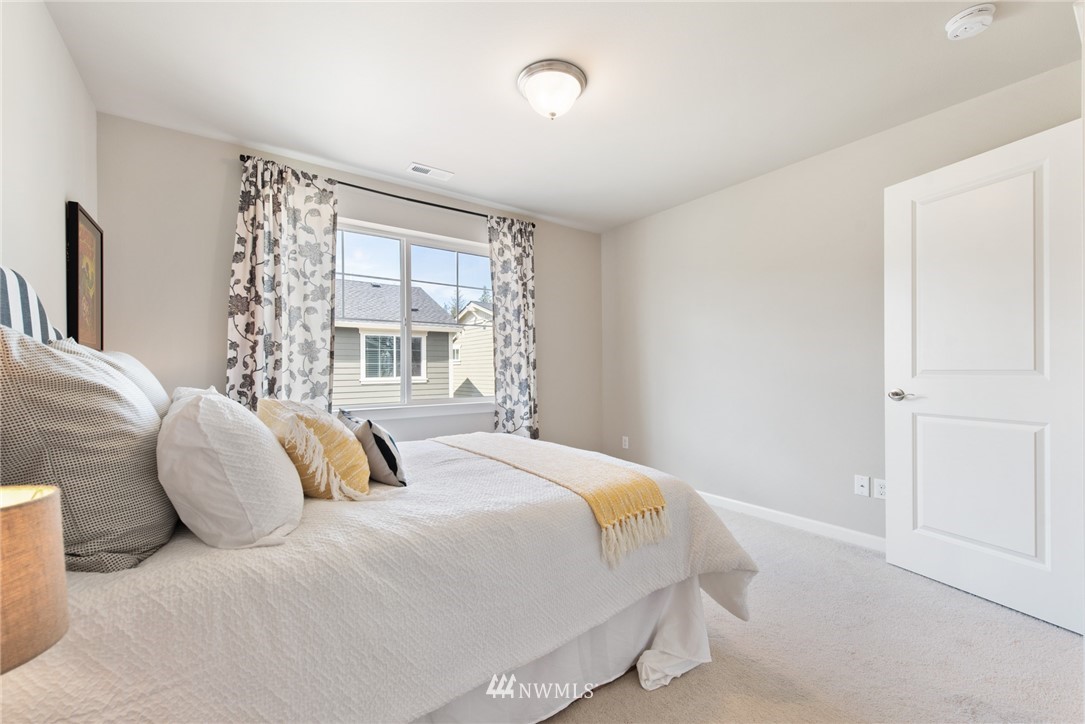 4528 185th Place Southeast Bothell, WA 98012 - Photo 22 of 34 a bedroom with a bed and a window