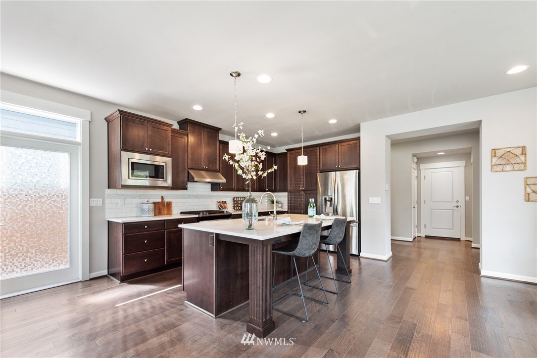 4528 185th Place Southeast Bothell, WA 98012 - Photo 8 of 34 a kitchen with cabinets and wooden floor