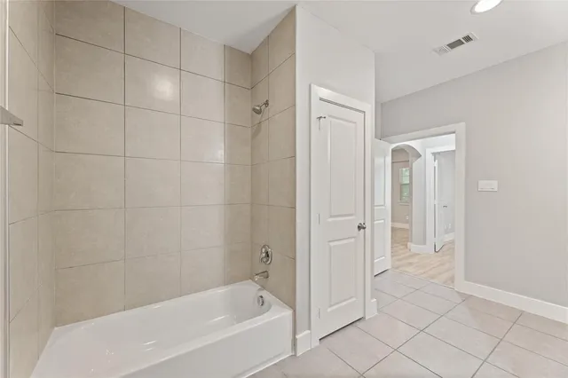 a bathroom with a bathtub and shower