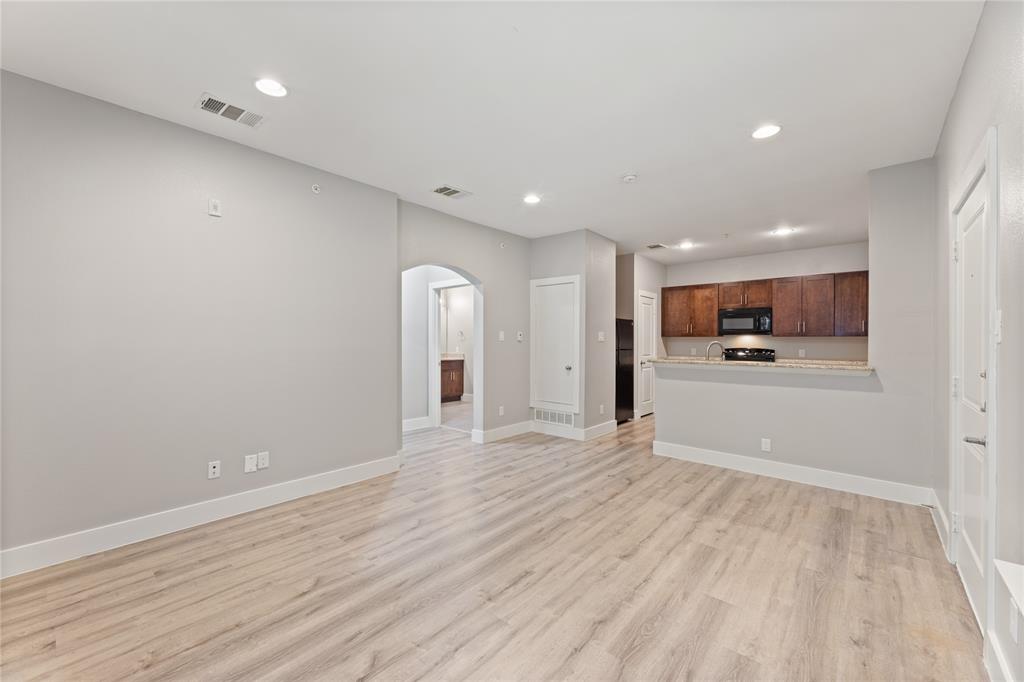 13609 Pinnacle Circle West, Unit 1101 Fort Worth, TX 76040 - Photo 8 of 21 a view of an empty room with kitchen and window