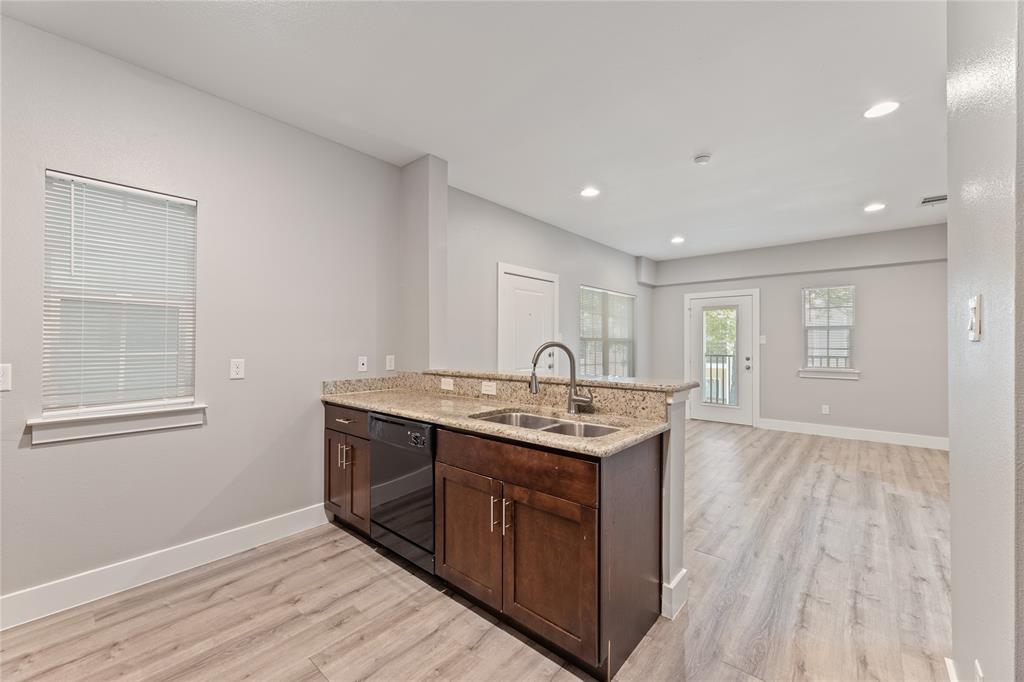 13609 Pinnacle Circle West, Unit 1101 Fort Worth, TX 76040 - Photo 10 of 21 a kitchen with a sink and wooden cabinets