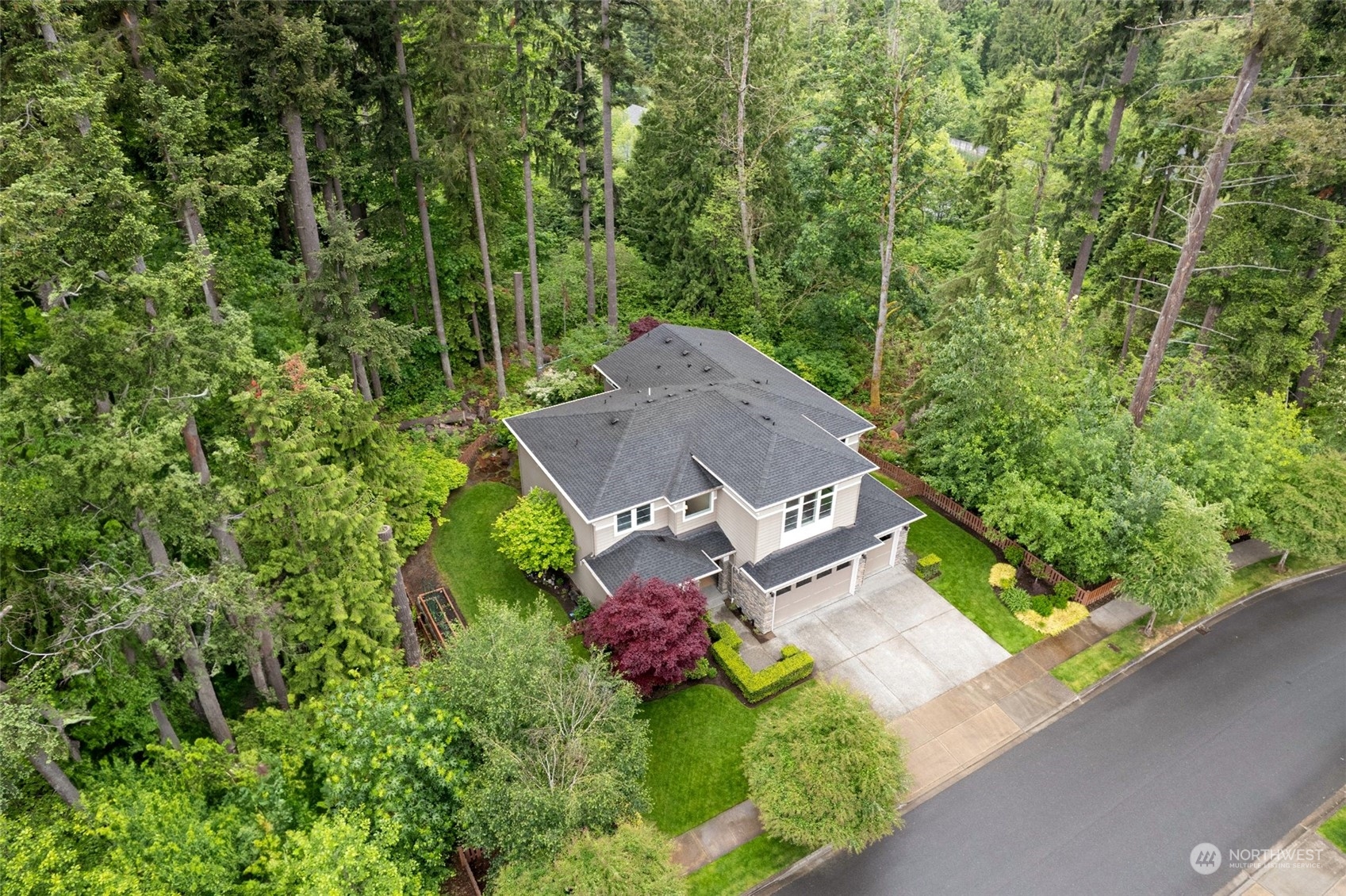 an aerial view of a house with yard and outdoor seating