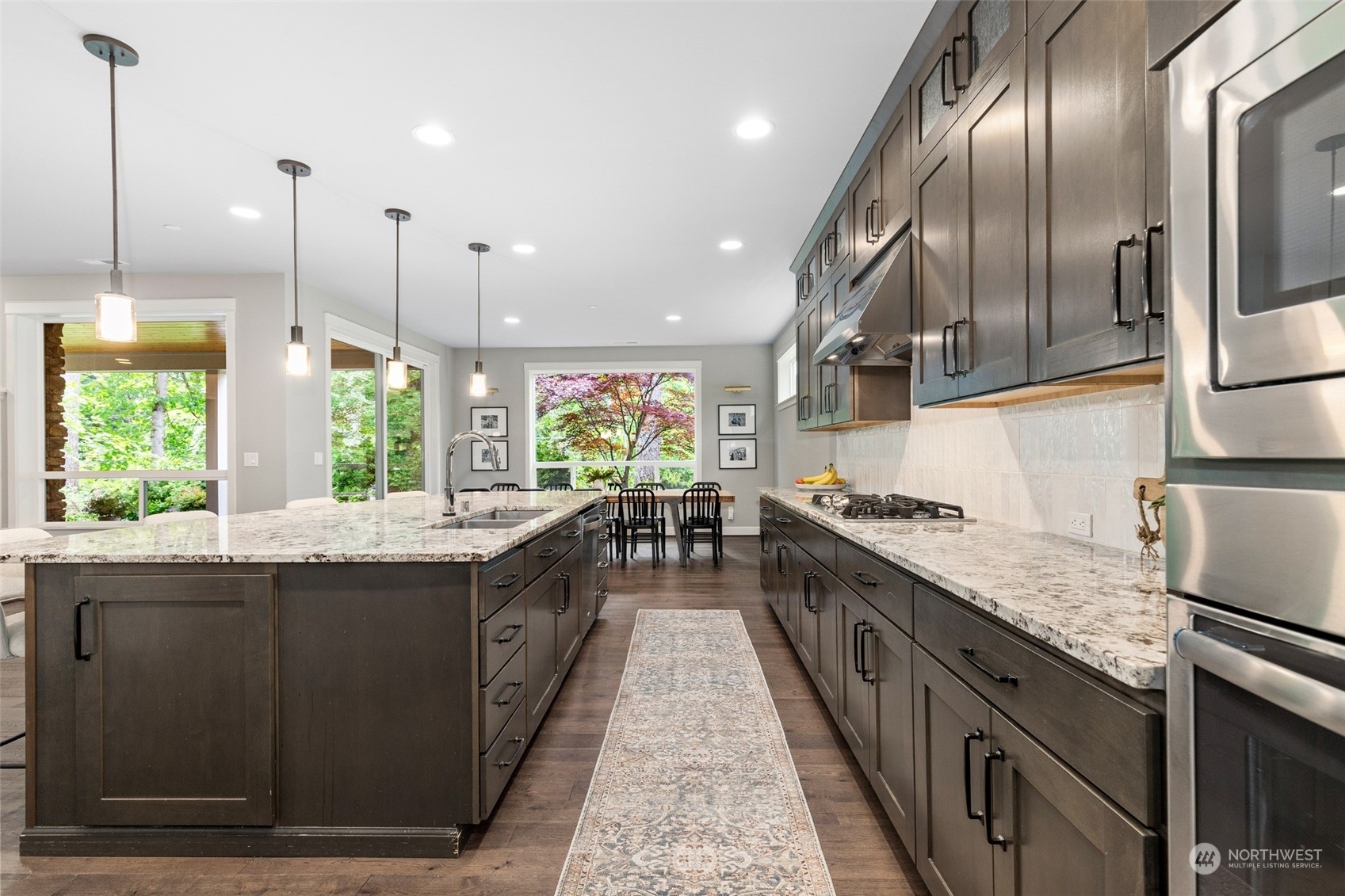 1607 233rd Street Southeast Bothell, WA 98021 - Photo 11 of 40 a large kitchen with stainless steel appliances granite countertop plenty wooden cabinets counter space a sink and a window