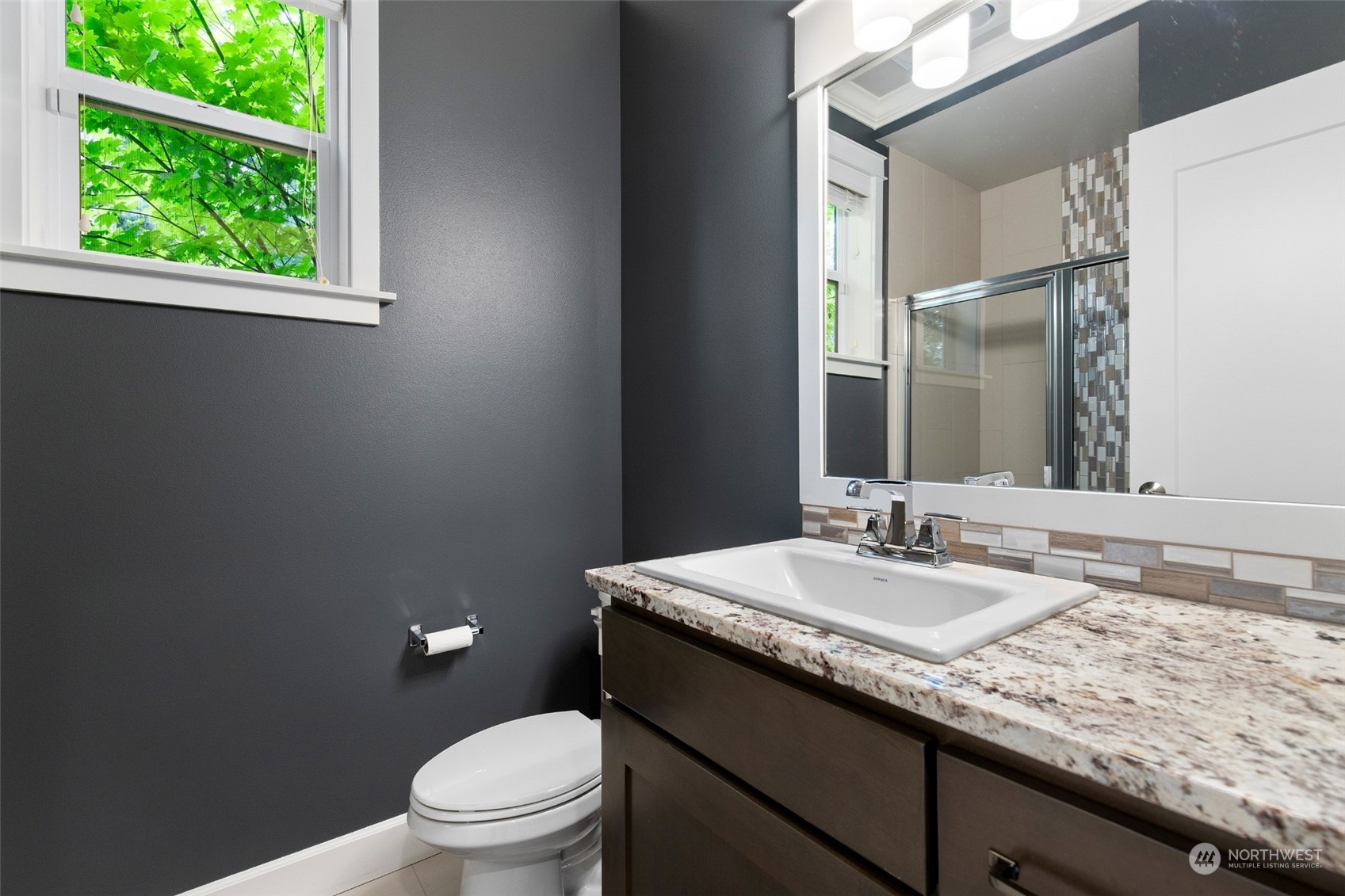 1607 233rd Street Southeast Bothell, WA 98021 - Photo 17 of 40 a bathroom with a granite countertop sink a toilet and a mirror