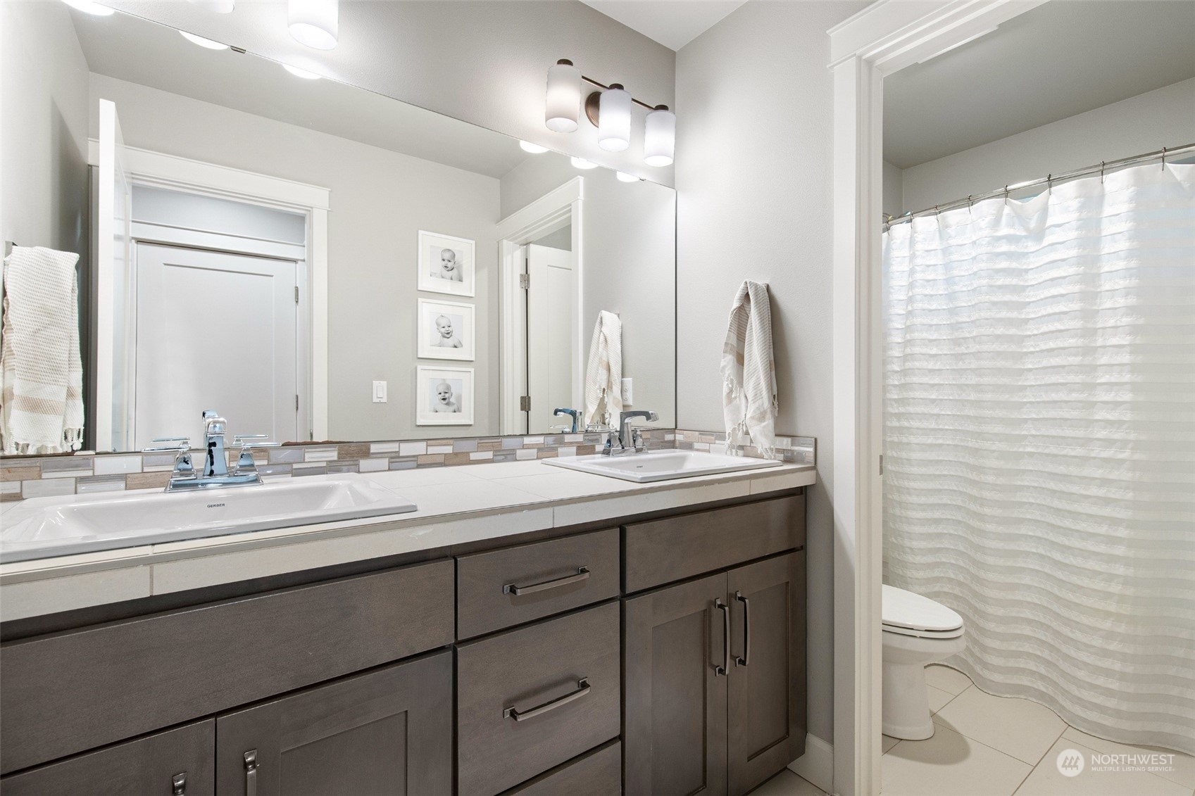 1607 233rd Street Southeast Bothell, WA 98021 - Photo 27 of 40 a bathroom with a double vanity sink toilet and a mirror