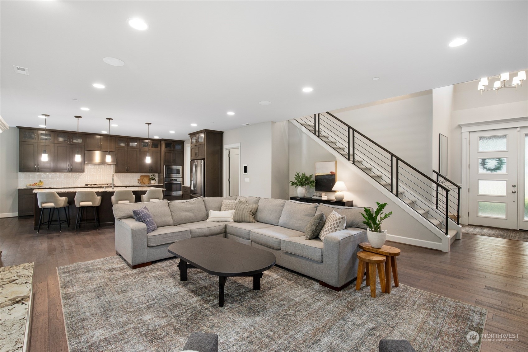 1607 233rd Street Southeast Bothell, WA 98021 - Photo 6 of 40 a living room with furniture and a dining table with wooden floor