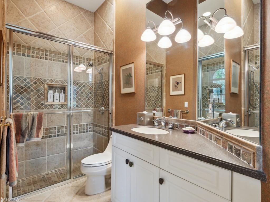 15352 Milan Lane Naples, FL 34110 - Photo 16 of 49 a bathroom with a toilet a sink and mirror