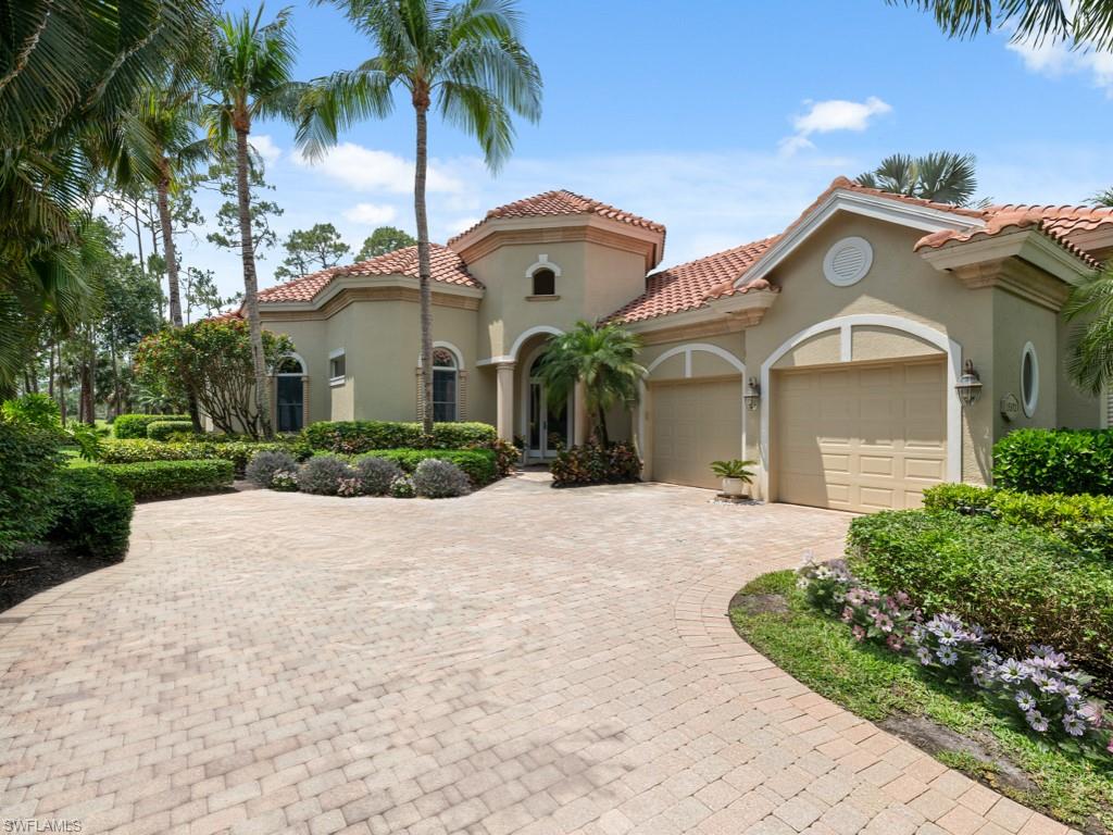 15352 Milan Lane Naples, FL 34110 - Photo 2 of 49 a front view of a house with garden