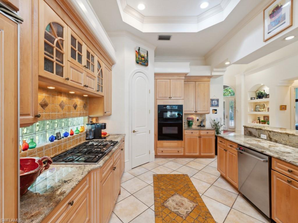 15352 Milan Lane Naples, FL 34110 - Photo 6 of 49 a large kitchen with stainless steel appliances granite countertop a stove and a sink